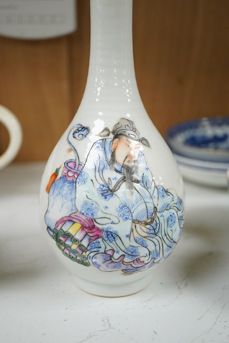A Chinese famille rose bottle vase decorated with a figure, 17cm high